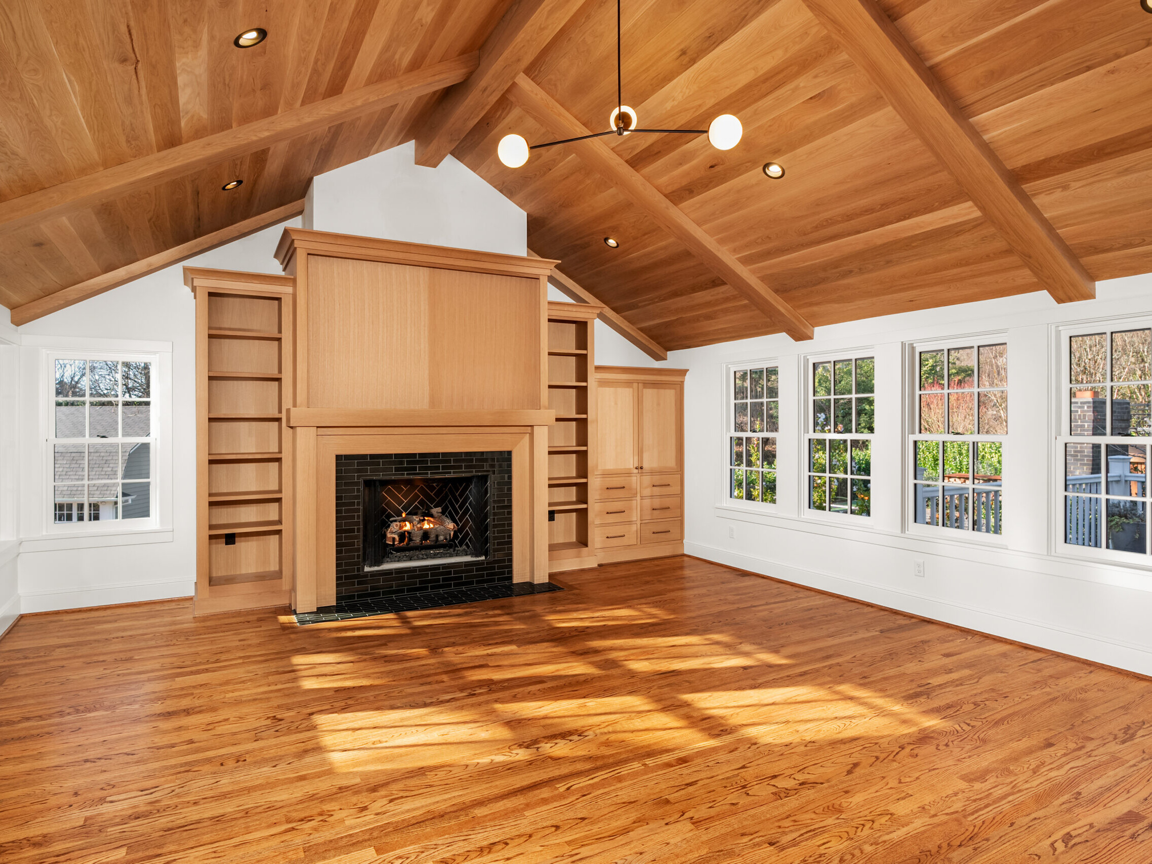 A room with a fireplace and wood floors.