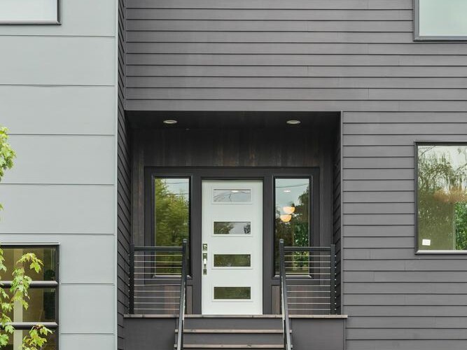 A building with stairs leading to the front door.